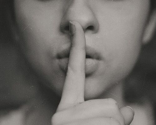 woman-finger-whisper-lip