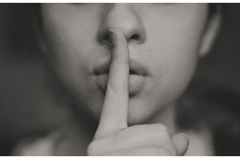 woman-finger-whisper-lip